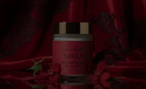 Cosmetic jar with red fabric and rose on a dark background